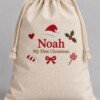 Cream organic cotton Santa sack with Noah and My First Christmas embroidery on a plain background